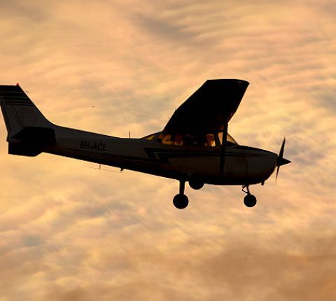 Luqa, Malta - December 6, 2014: Malta School of Flying Cessna 172M Skyhawk overflying runway 31 in the sunset.